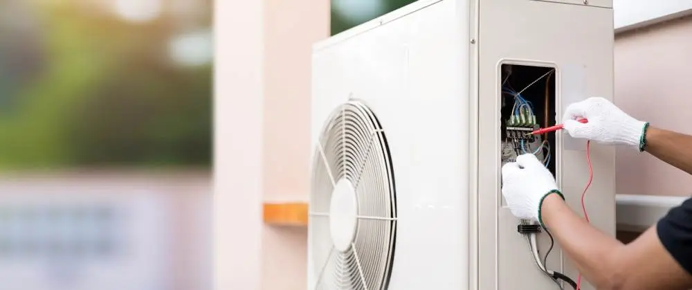 A technician works on a heat pump.