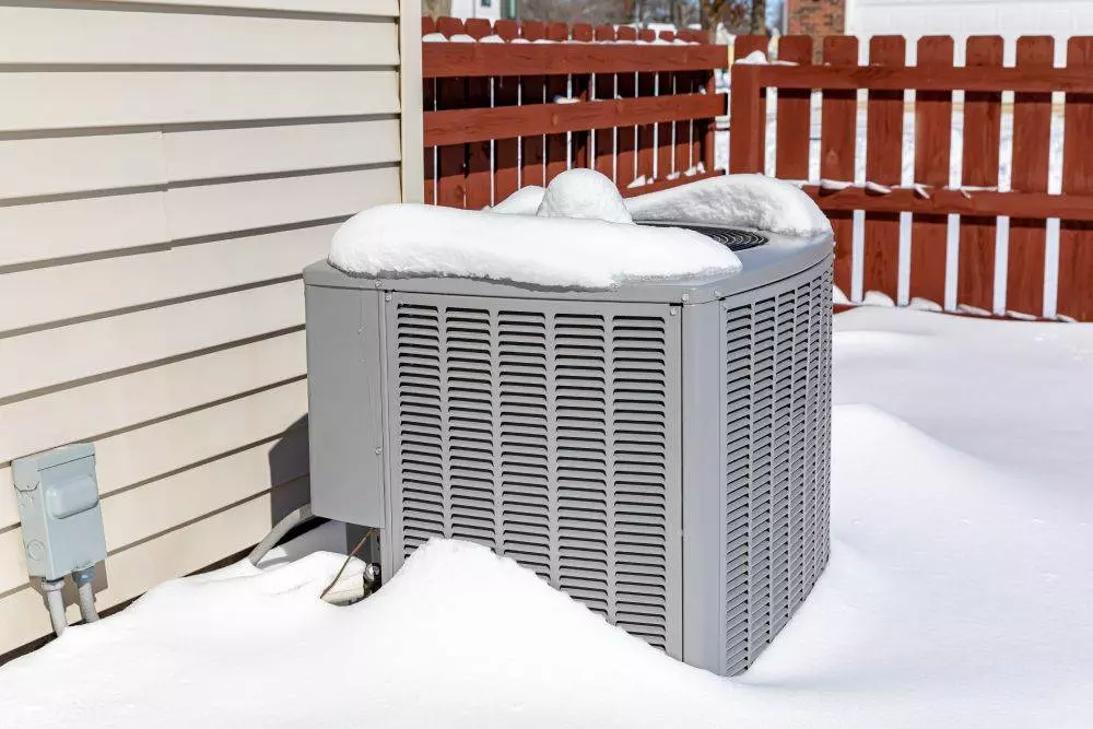 Air conditioning unit covered in snow